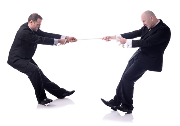 two businessmen in a tug of war isolated on white background